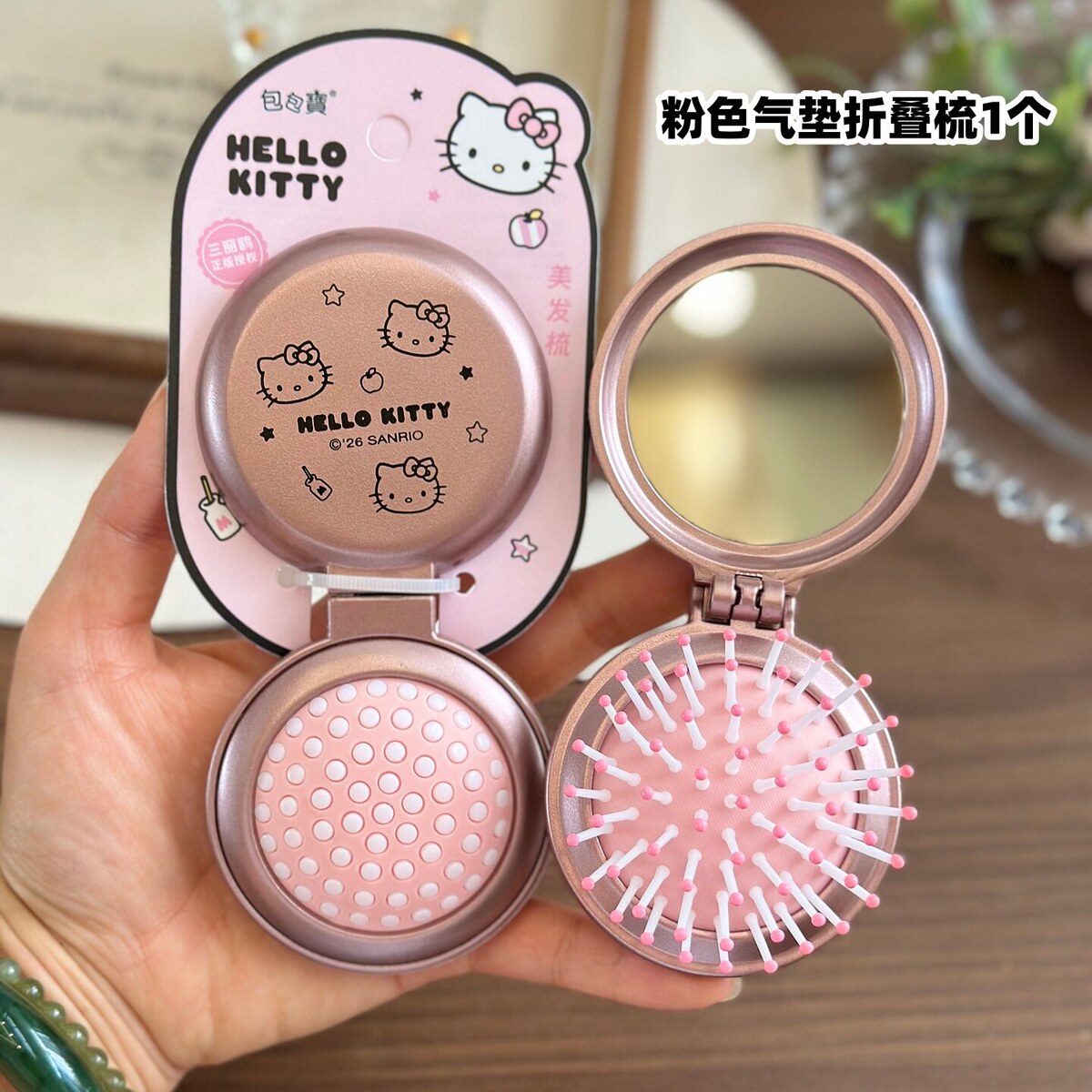 Rose pink Hello Kitty folding air-cushion comb with mirror open on official Sanrio packaging card