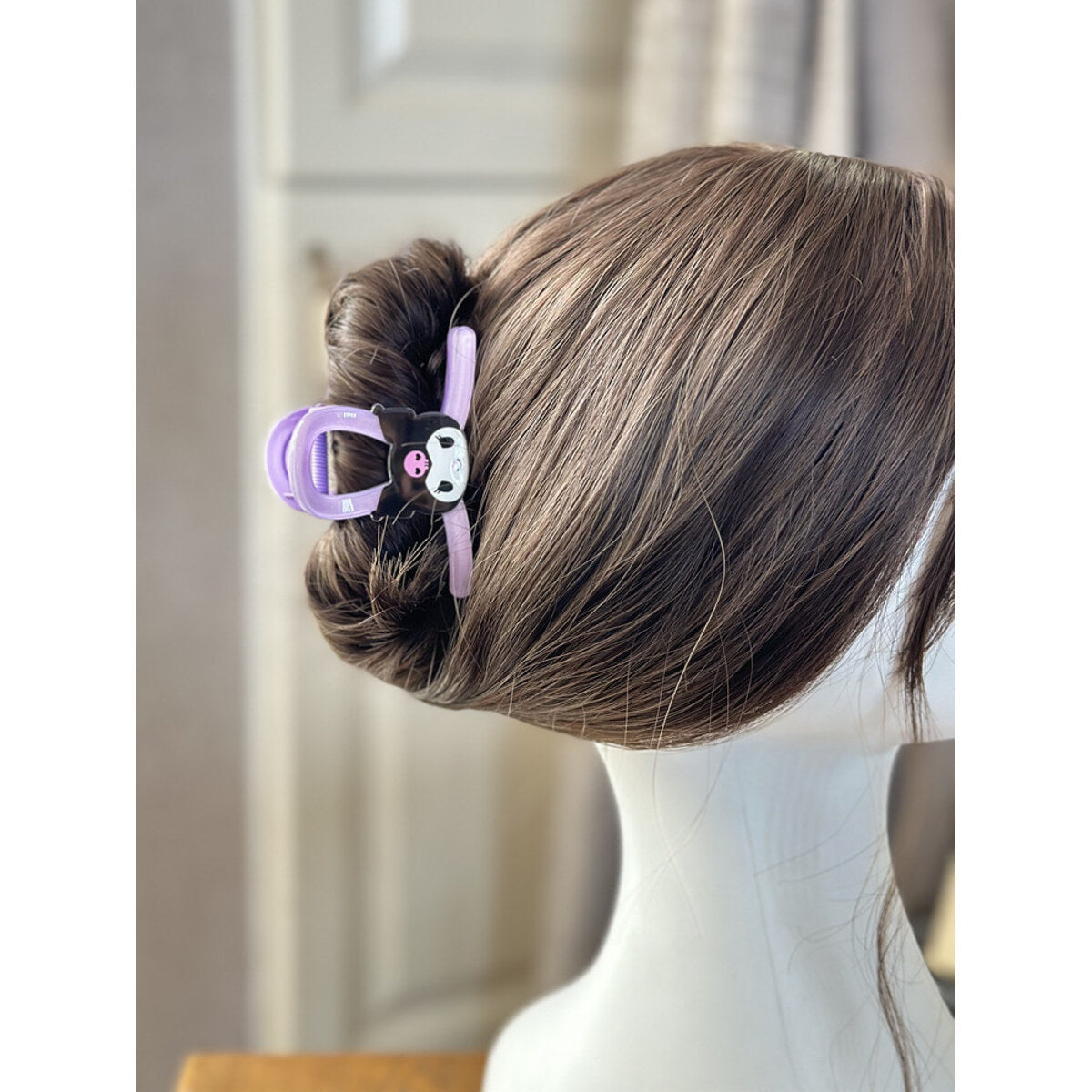 Kuromi glitter claw clip worn in a bun on a mannequin