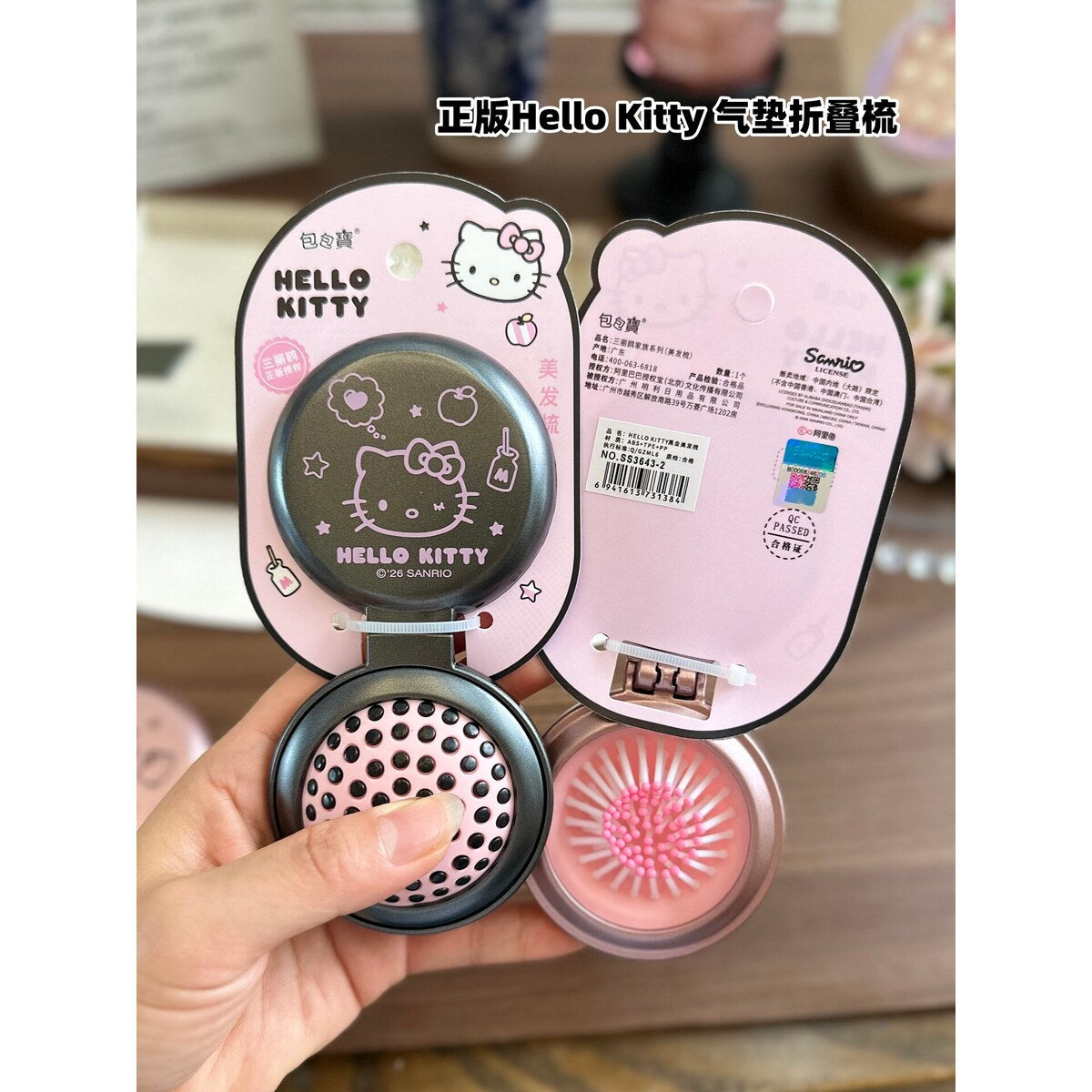 Rose pink and black Hello Kitty folding combs open showing mirror and brush heads