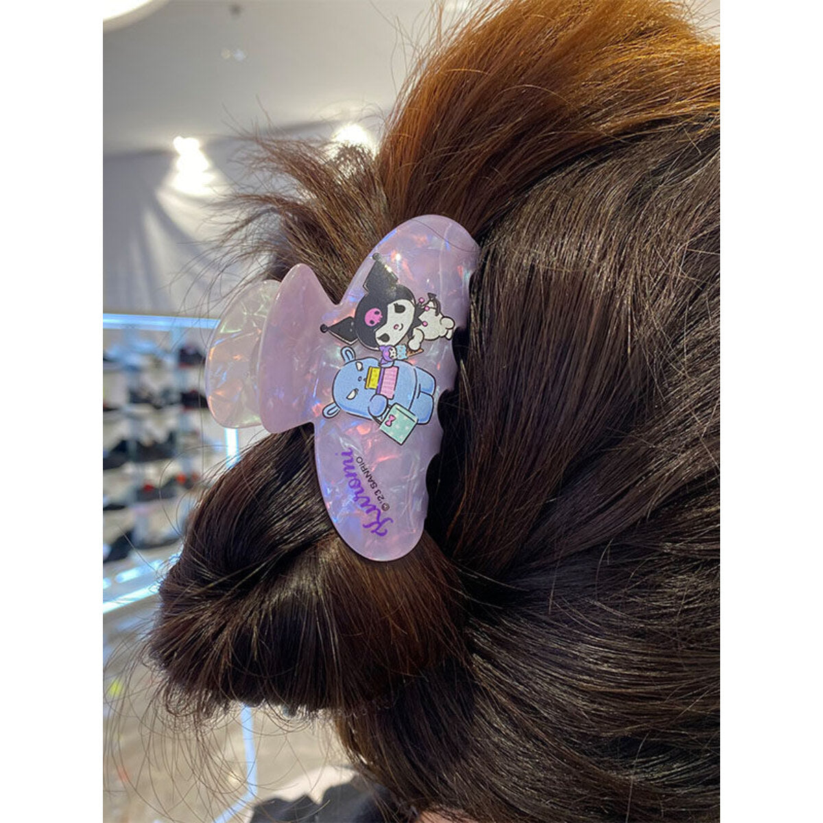 Kuromi holographic claw clip worn in a bun