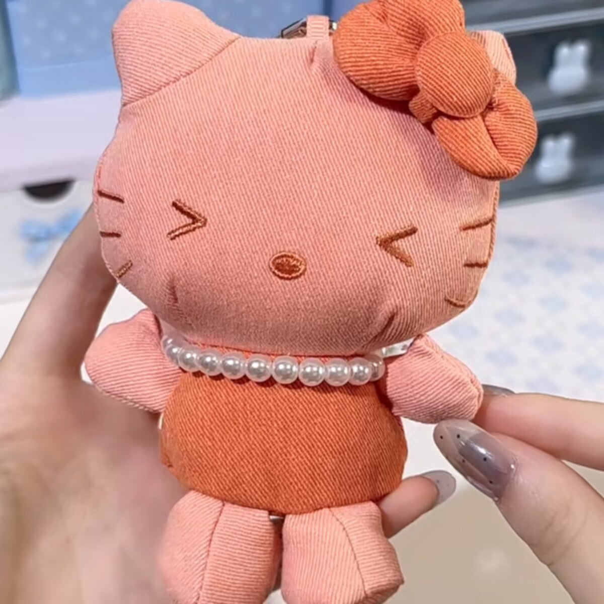 Hello Kitty denim series plush charm in orange corduroy with orange bow