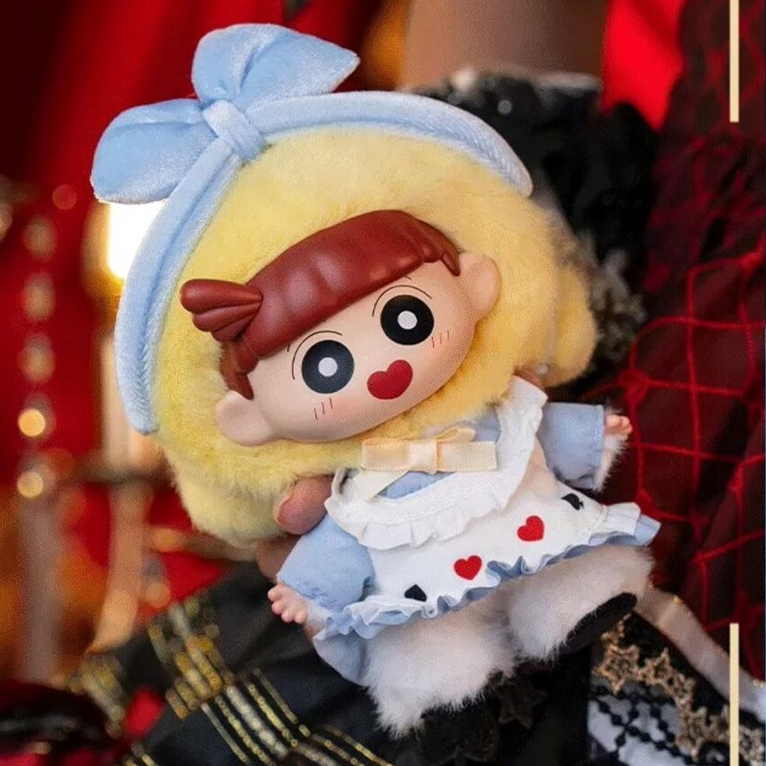 Nene vinyl plush pendant with yellow curls and a blue bow