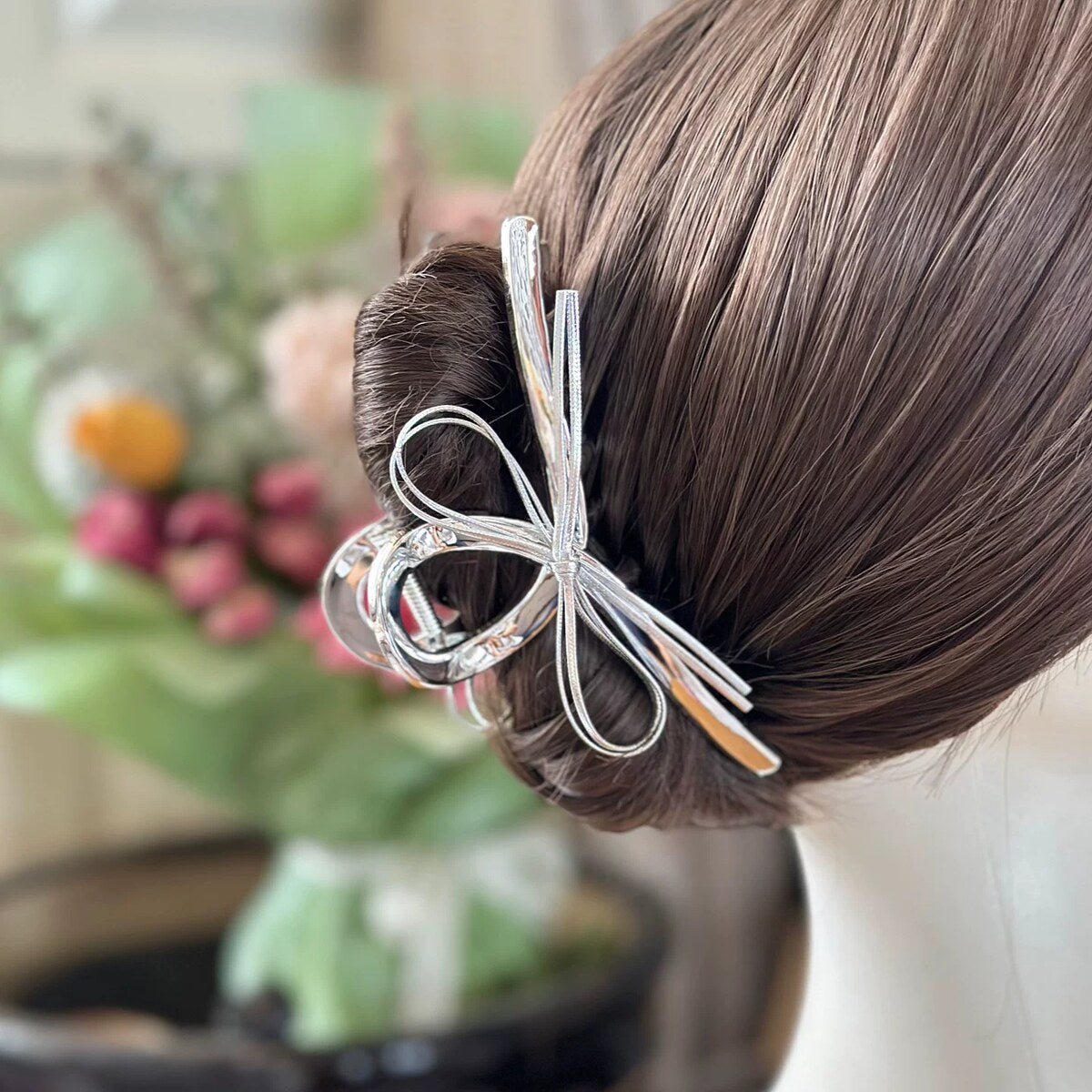 AB double-sided bow claw clip styled in an updo