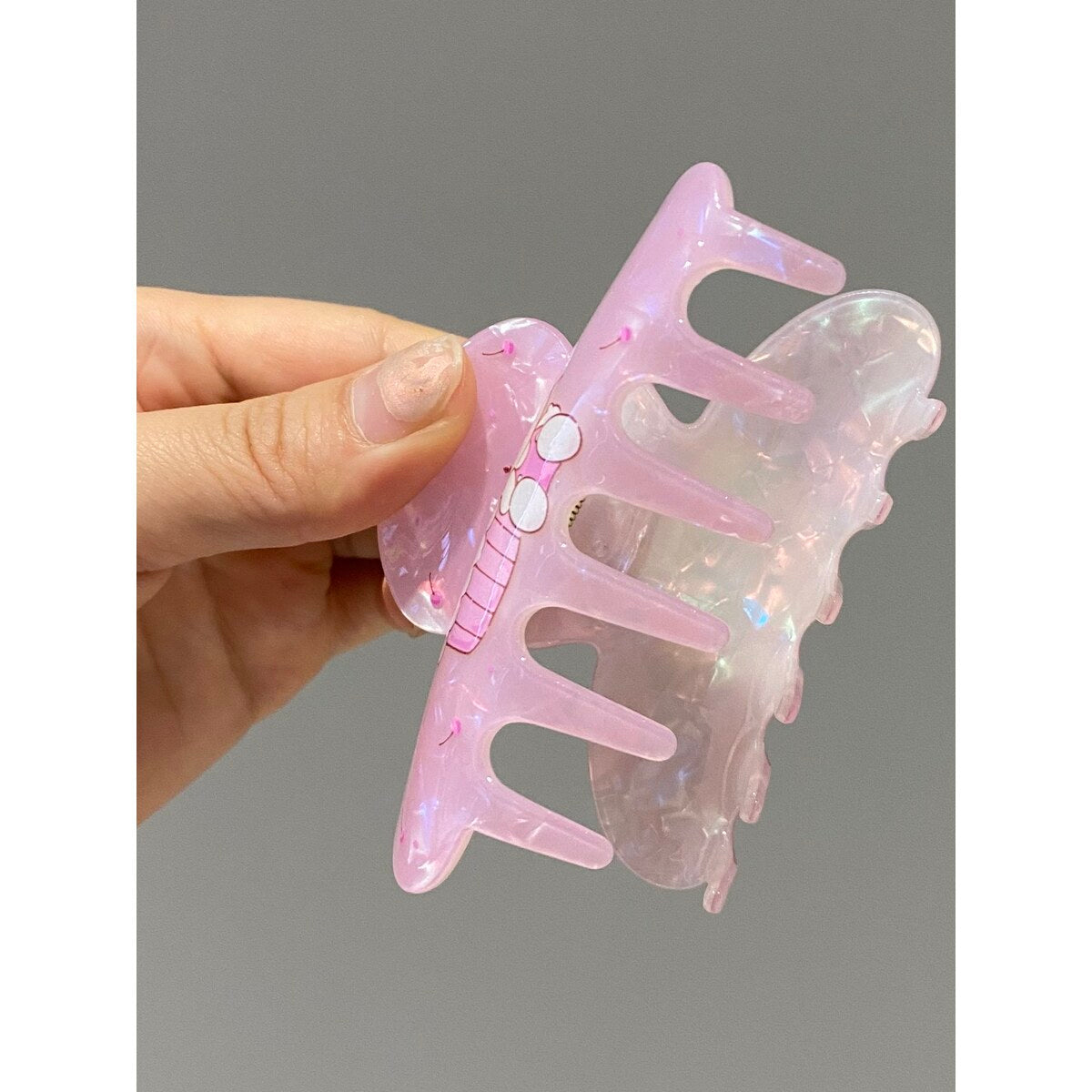 Hello Kitty pearlescent pink claw clip close-up showing clip teeth