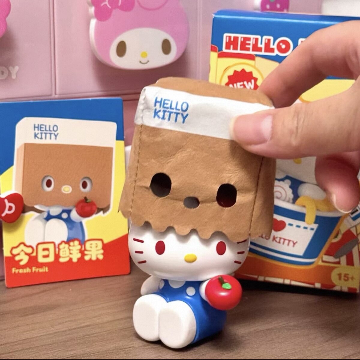 Hello Kitty Fresh Fruit figure wearing a paper bag and holding an apple