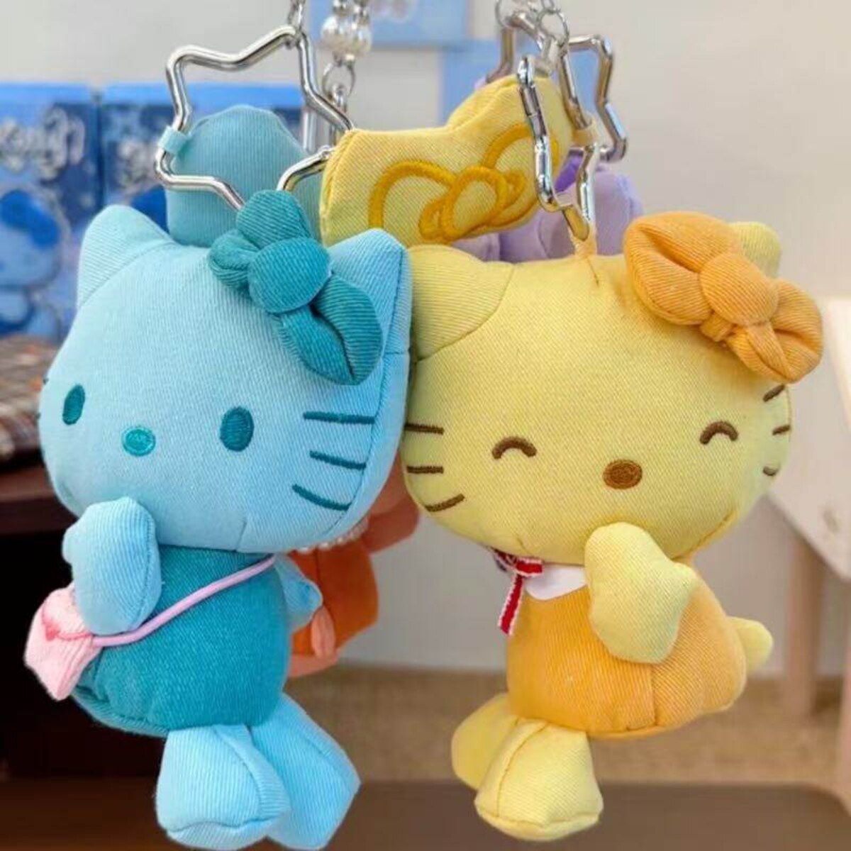 Hello Kitty denim series plush charms in blue and yellow with bow charms and star clasps