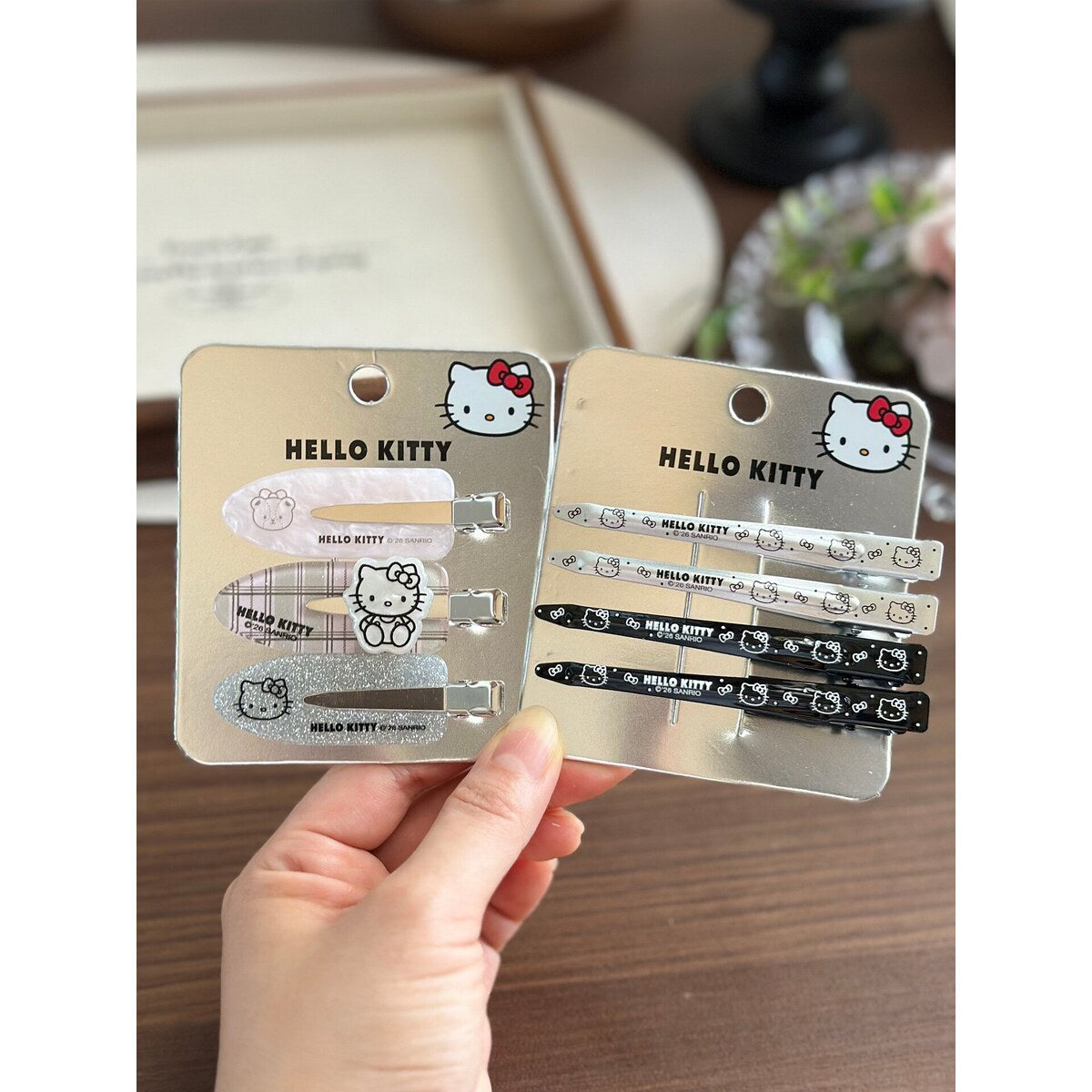 Sanrio Hello Kitty metal and acrylic no-crease hair clip sets in hand - genuine licensed accessories