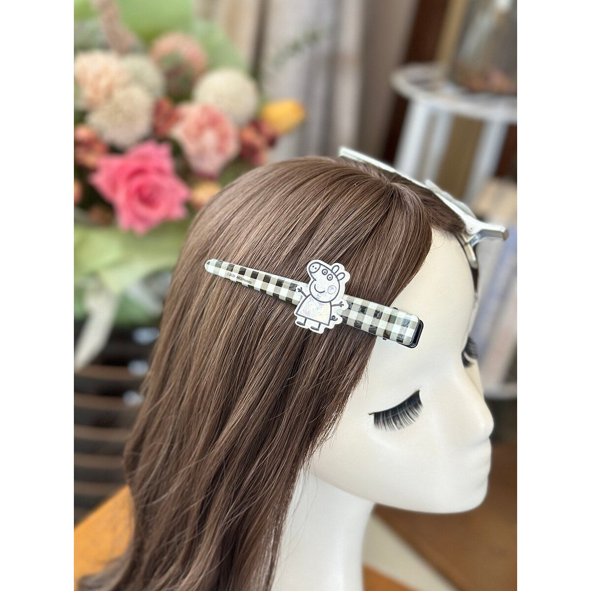 Girl wearing Peppa Pig gingham bar hair clip