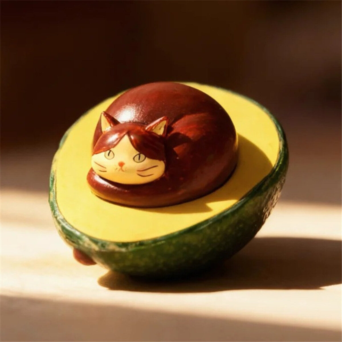 Avocado Cat sitting in half an avocado from the 52TOYS x COMUGI Fruit Cat Series