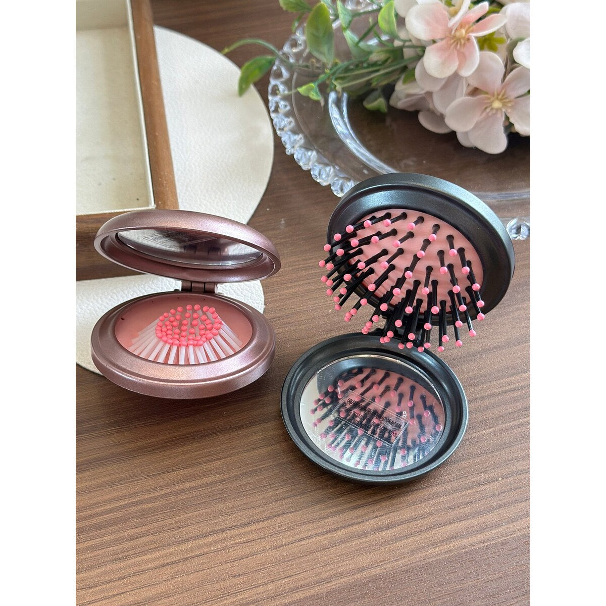 Black Hello Kitty folding comb brushing through long hair with air-cushion bristles