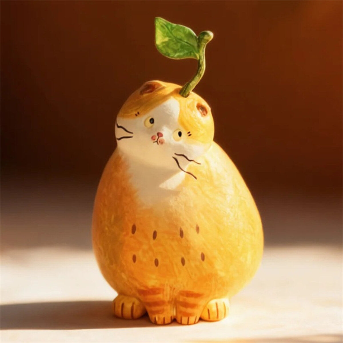Pear Cat figure with a leaf on top from the 52TOYS x COMUGI Fruit Cat Series