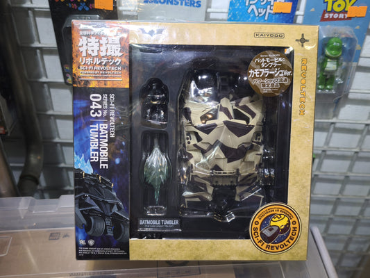 Back of the packaging for the Kaiyodo Sci-Fi Revoltech No. 043EX Batmobile Tumbler action figure, showcasing product features including tire articulation, opening cockpit hatch, jet engine flame effect parts, and a miniature Batman figure setup instructions.