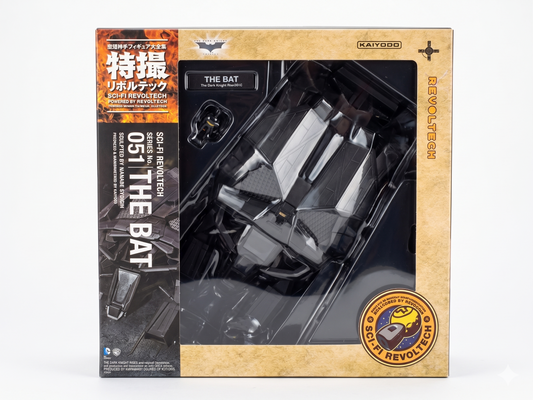 Back of the retail packaging for the Kaiyodo Sci-Fi Revoltech No. 051 The Bat vehicle action figure, showcasing product features including engine articulation, opening cockpit hatch with a boarding miniature Batman figure, movable tail wings, and display stand setup.