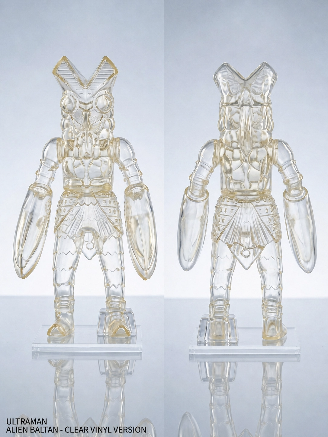 Front and back view of the clear vinyl Ultraman Alien Baltan 25cm figure by Play Toy, showcasing its transparent PVC-vinyl body and iconic large claws against a light background, as seen in baltan_clean.png.