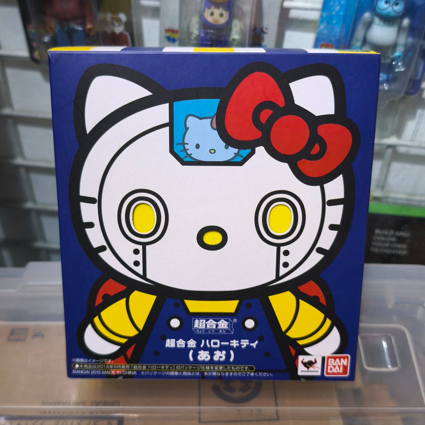 Front panel of the Bandai Tamashii Nations Chogokin Hello Kitty Blue packaging, featuring a bold graphic of Hello Kitty styled as a mechanical mecha robot with a mini-pilot visible in the head.