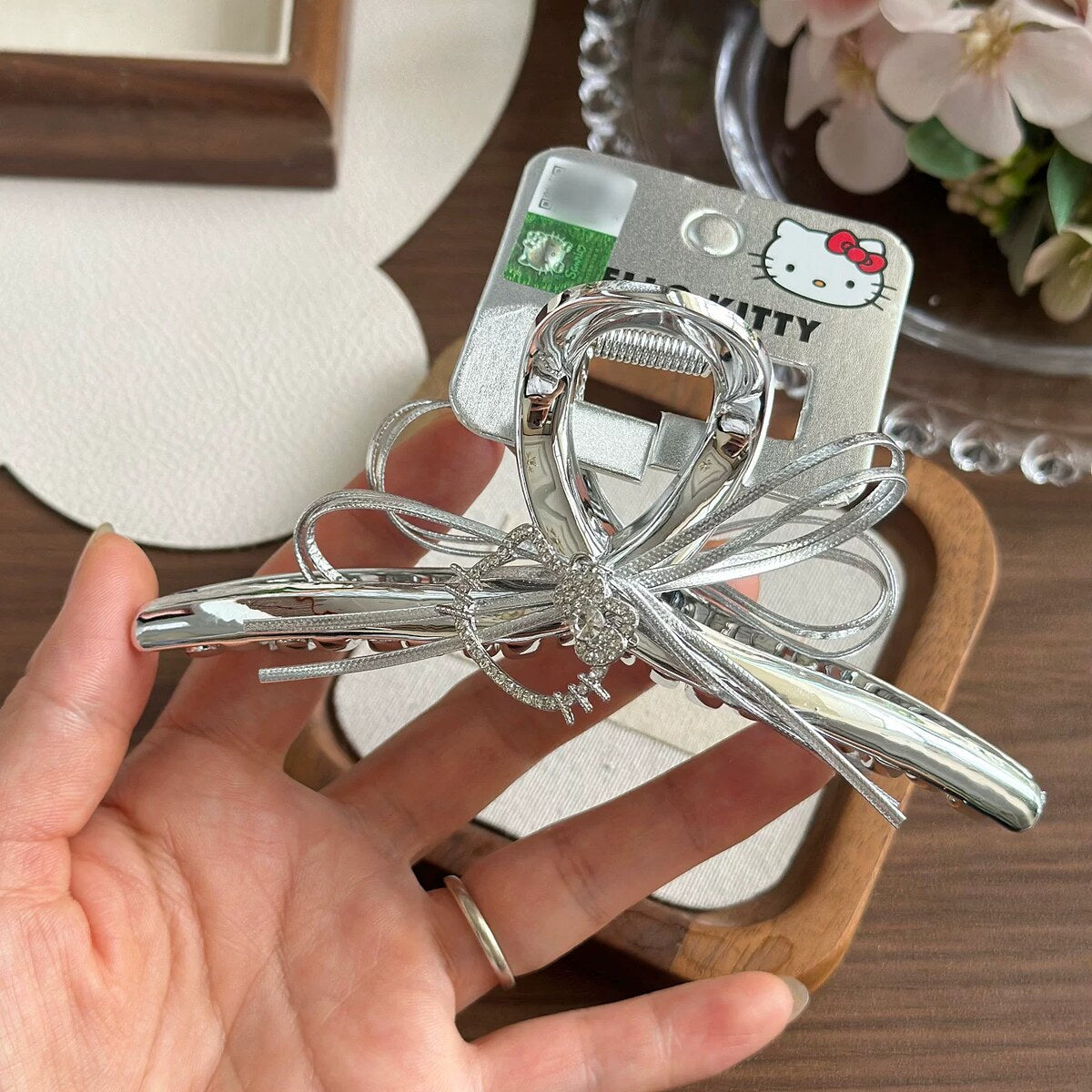 Hello Kitty silver bow claw clip held in hand