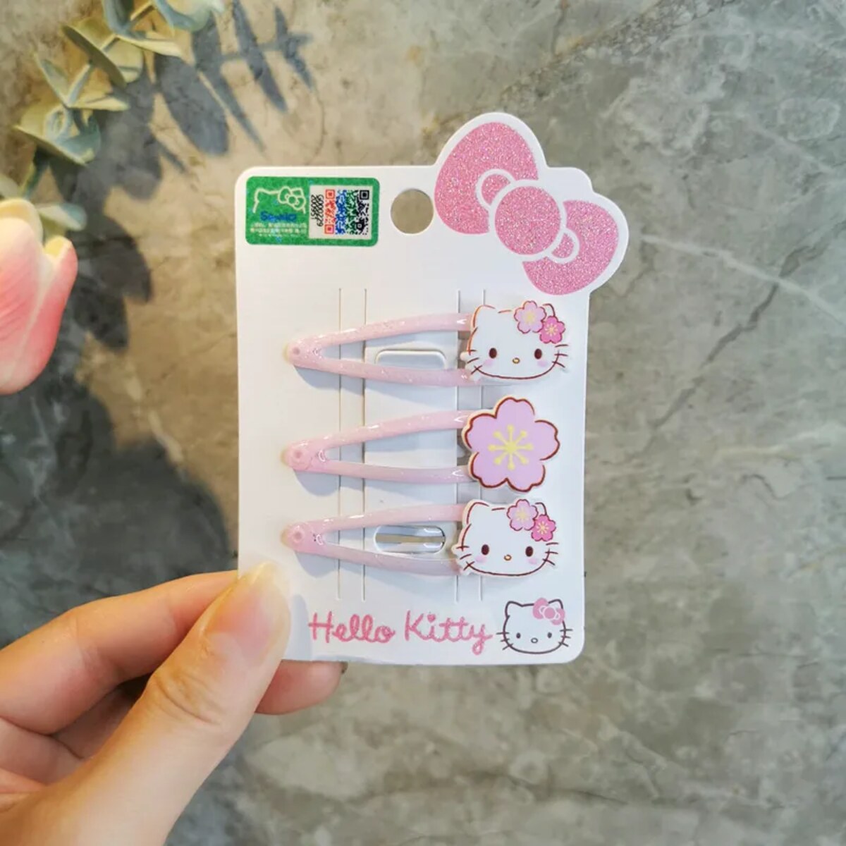 Hello Kitty cherry blossom BB hair clip collection flat lay, licensed Sanrio sakura pink hair accessories