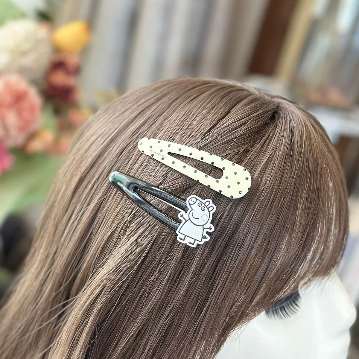 Girl wearing Peppa Pig water drop snap hair clips