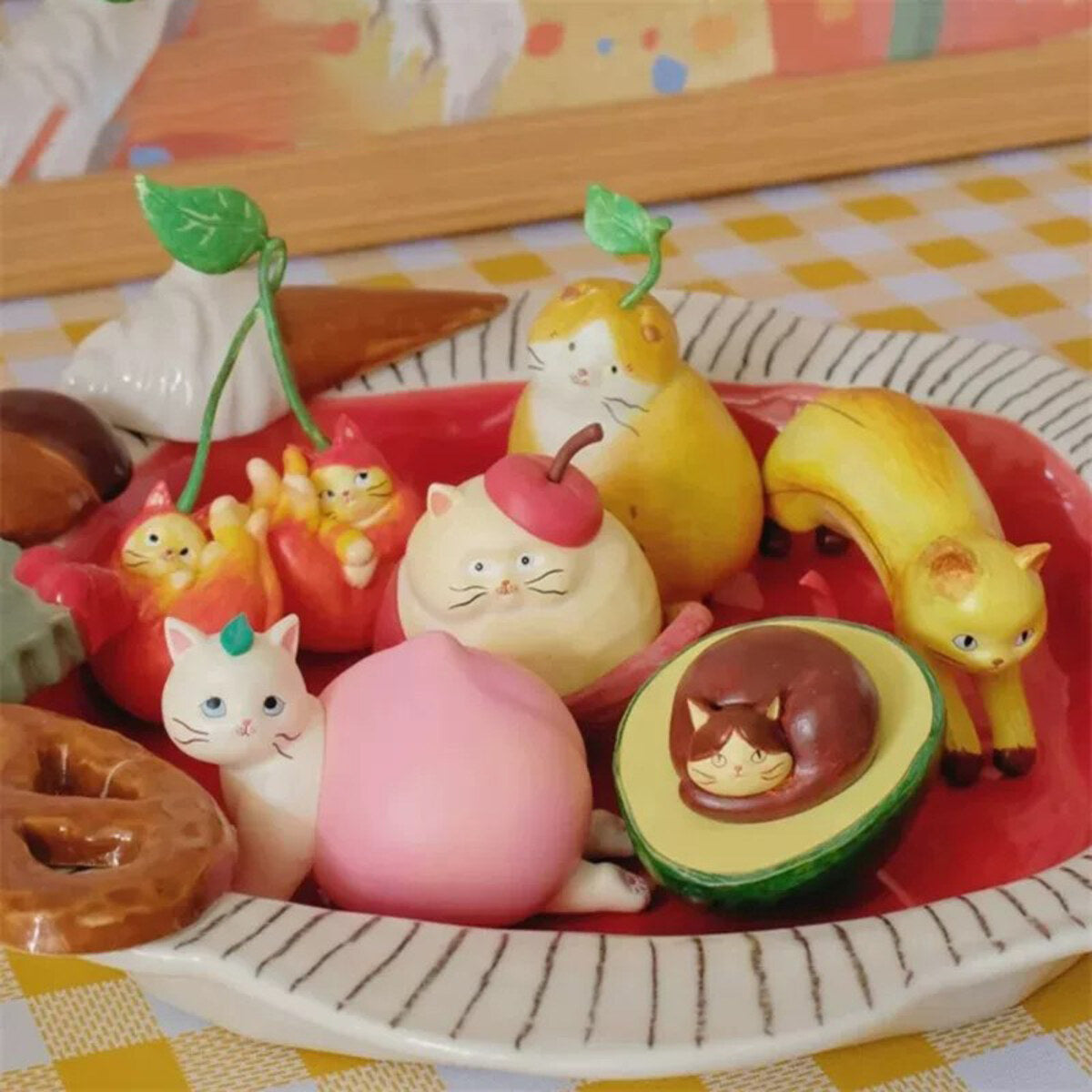52TOYS x COMUGI Fruit Cat Series blind box figures on a plate